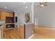 Open kitchen area with granite countertops and a view of the wooden staircase leading to the upper level at 2001 Dobson Ct, Raleigh, NC 27612