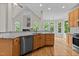 Open-concept kitchen with island, stainless steel appliances, and hardwood floors at 2001 Dobson Ct, Raleigh, NC 27612