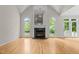 Bright living room with a fireplace, vaulted ceilings, hardwood floors and plenty of natural light at 2001 Dobson Ct, Raleigh, NC 27612