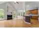 Spacious living room featuring a fireplace, hardwood floors and kitchen view at 2001 Dobson Ct, Raleigh, NC 27612