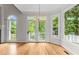 Bright living room featuring a chandelier and multiple windows with beautiful views of the outdoor greenery at 2001 Dobson Ct, Raleigh, NC 27612