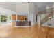 Open-concept living area with hardwood floors, staircase, and kitchen featuring an island with granite countertops at 2001 Dobson Ct, Raleigh, NC 27612