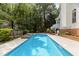 Backyard area with beautiful pool, waterfall, manicured lawn and patio space at 2001 Dobson Ct, Raleigh, NC 27612