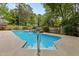 Sparkling in-ground pool with a waterfall feature and concrete surround, perfect for relaxing or entertaining at 2001 Dobson Ct, Raleigh, NC 27612