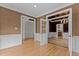Room with hardwood floors and access to kitchen and dining room at 2001 Dobson Ct, Raleigh, NC 27612