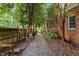 Brick home features a stone pathway on the side yard offering lush landscaping at 2001 Dobson Ct, Raleigh, NC 27612