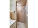 Bathroom featuring tiled shower and floors, with vintage wallpaper at 2016 Tryon Rd, Raleigh, NC 27603
