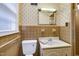 Cozy bathroom featuring a vanity, toilet, and shower with brown tiling at 2016 Tryon Rd, Raleigh, NC 27603