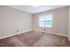 A simple bedroom with natural light and neutral carpet at 2016 Tryon Rd, Raleigh, NC 27603
