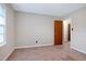 Bedroom featuring neutral walls and carpet with window and closet at 2016 Tryon Rd, Raleigh, NC 27603