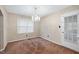 Charming dining room with chandelier, window, and door to the backyard at 2016 Tryon Rd, Raleigh, NC 27603