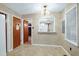 Cozy dining room with neutral wallpaper, vintage chandelier and convenient pass-through at 2016 Tryon Rd, Raleigh, NC 27603
