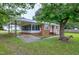 Exterior side view of brick home showing screened porch and driveway at 2016 Tryon Rd, Raleigh, NC 27603