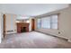 Spacious living room boasts a brick fireplace and large window at 2016 Tryon Rd, Raleigh, NC 27603