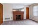 A cozy living room offers a brick fireplace, neutral walls and carpet at 2016 Tryon Rd, Raleigh, NC 27603