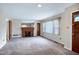 An open living room featuring a brick fireplace, neutral paint, and carpet at 2016 Tryon Rd, Raleigh, NC 27603