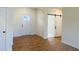 Inviting entryway with natural wood flooring, white trim, interior door, and a sliding barn door at 204 Seahawk Way, Zebulon, NC 27597