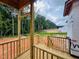 Unfinished porch with wood railing showcasing view of the construction site, clearing, and beautiful mature trees in the background at 204 Seahawk Way, Zebulon, NC 27597