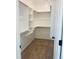 Well-organized walk-in closet featuring custom shelving, carpet, and wooden closet rods at 204 Seahawk Way, Zebulon, NC 27597