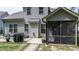 View of home's exterior with a screened-in porch, patio, and well-maintained lawn at 212 Hardwick St, Clayton, NC 27527