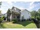 A spacious backyard with a well-manicured lawn, patio, and screened-in porch at 212 Hardwick St, Clayton, NC 27527
