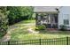 A spacious backyard with a well-manicured lawn, patio, and screened-in porch at 212 Hardwick St, Clayton, NC 27527
