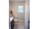 Bathroom featuring a shower, a toilet, and a vanity with a sink and a window at 212 Hardwick St, Clayton, NC 27527