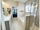 This bathroom features double sinks, a bathtub, a shower, and a view to the Primary bedroom at 212 Hardwick St, Clayton, NC 27527