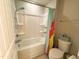 Bathroom with a tub/shower combo featuring a shower curtain, and a toilet with a basket at 212 Hardwick St, Clayton, NC 27527