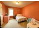 Bright orange bedroom with neutral carpet, a double window, and a pink accent table at 212 Hardwick St, Clayton, NC 27527