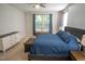 This bedroom features a ceiling fan, carpeted floor, a window, and blue curtains at 212 Hardwick St, Clayton, NC 27527
