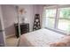 Cozy purple-toned bedroom with neutral carpet, a double window, and a playful sign at 212 Hardwick St, Clayton, NC 27527