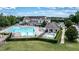 Aerial view of a large community pool area with water slide, seating, and shaded pavilion at 212 Hardwick St, Clayton, NC 27527