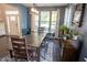 Inviting dining room with natural light, wooden furniture, and area rug at 212 Hardwick St, Clayton, NC 27527