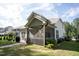 A spacious backyard with a well-manicured lawn, patio, and screened-in porch at 212 Hardwick St, Clayton, NC 27527