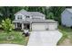Charming two-story home with a three car garage and a well manicured front yard at 212 Hardwick St, Clayton, NC 27527
