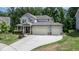 Charming two-story home with a three car garage and a well manicured front yard at 212 Hardwick St, Clayton, NC 27527