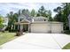Two-story home showcasing its double garage and clean, well-maintained lawn and landscaping at 212 Hardwick St, Clayton, NC 27527
