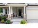 A close-up of the home's front porch with stone support columns and welcome decor at 212 Hardwick St, Clayton, NC 27527