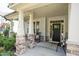 Inviting front porch with stone accents, seating, and a clear view of the front door at 212 Hardwick St, Clayton, NC 27527
