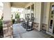 A charming covered front porch featuring relaxing seating arrangements and decorative pillows at 212 Hardwick St, Clayton, NC 27527