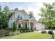 Charming two-story home with an American flag, landscaped yard, and inviting front porch at 212 Hardwick St, Clayton, NC 27527