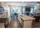 Modern open kitchen layout with a central island, stainless steel appliances, and a view into the living area at 212 Hardwick St, Clayton, NC 27527