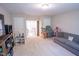 Bright playroom featuring a TV, shelving, sofa, and staircase access at 212 Hardwick St, Clayton, NC 27527