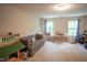 Spacious playroom with natural light, sofa, play market, and built-in shelving for toys at 212 Hardwick St, Clayton, NC 27527