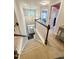 Carpeted stairs ascend from the entryway, showcasing the home's bright, open two-story foyer at 212 Hardwick St, Clayton, NC 27527