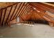 Unfinished attic space with exposed beams and potential for customization at 220 Dalton Dr, Raleigh, NC 27615