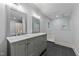 Modern bathroom featuring a dual sink vanity with marble countertop, and a glass-enclosed shower at 220 Dalton Dr, Raleigh, NC 27615