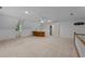 Bonus room with a bar, large window, and staircase with white railings at 220 Dalton Dr, Raleigh, NC 27615