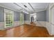 A formal dining area showcasing hardwood flooring, neutral tones, and a modern linear light fixture at 220 Dalton Dr, Raleigh, NC 27615